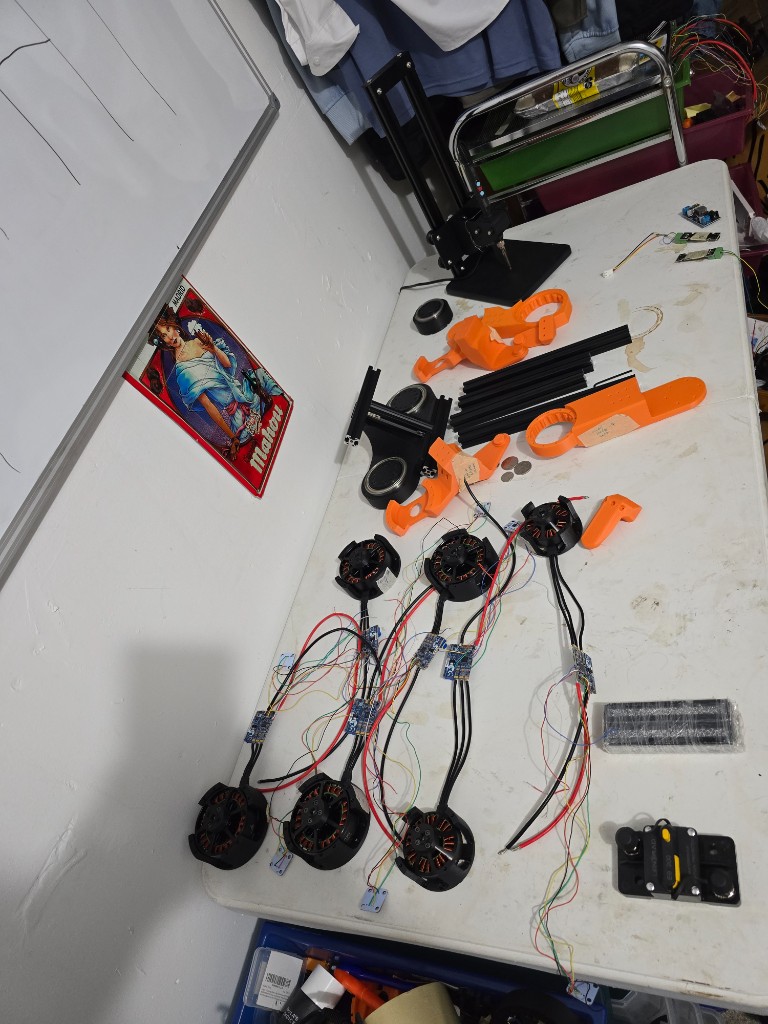 Six open-frame actuators on the bench, each wired to a blue motor controller.